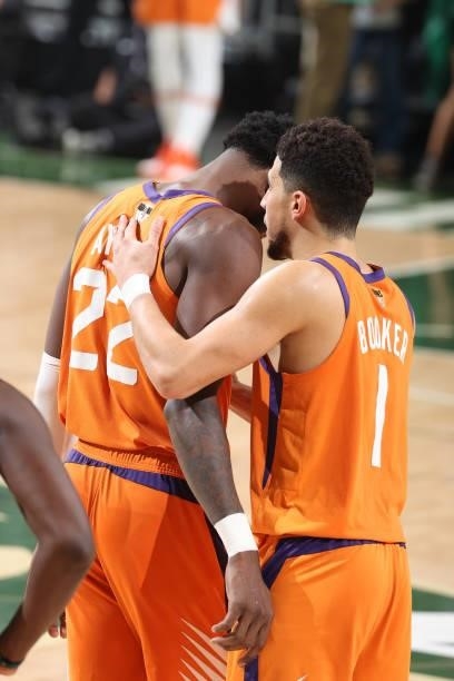 Deandre Ayton talks with Devin Booker of the Phoenix Suns during Game Six of the 2021 NBA Finals on July 20, 2021 at the Fiserv Forum in Milwaukee,...