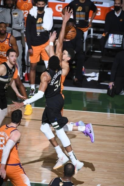 Giannis Antetokounmpo of the Milwaukee Bucks blocks a shot by Devin Booker of the Phoenix Suns during Game Six of the 2021 NBA Finals on July 20,...