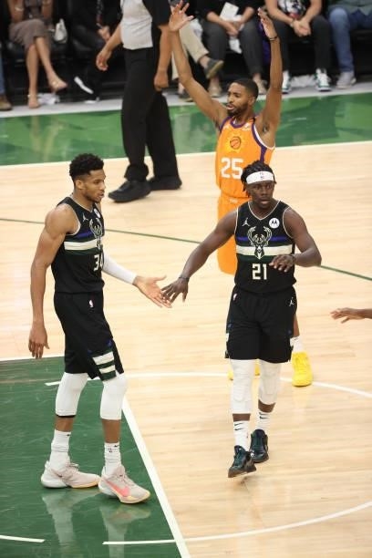 Giannis Antetokounmpo of the Milwaukee Bucks high fives Jrue Holiday of the Milwaukee Bucks during Game Six of the 2021 NBA Finals on July 20, 2021...