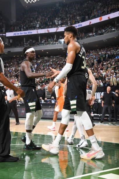 Jrue Holiday of the Milwaukee Bucks high fives Giannis Antetokounmpo of the Milwaukee Bucks during the game against the Phoenix Suns during Game Six...