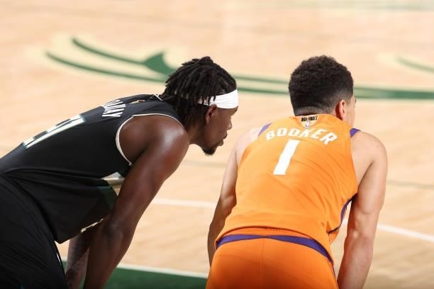 Jrue Holiday of the Milwaukee Bucks and Devin Booker of the Phoenix Suns look on during Game Six of the 2021 NBA Finals on July 20, 2021 at the...