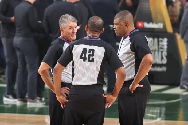 Referee Scott Foster, referee Eric Lewis and referee Tony Brothers talk during the game between the Phoenix Suns and the Milwaukee Bucks during Game...