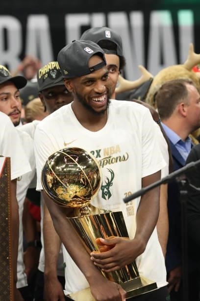 Khris Middleton of the Milwaukee Bucks celebrates with the Larry O'Brien trophy after winning the 2021 NBA Finals on July 20, 2021 at Fiserv Forum in...