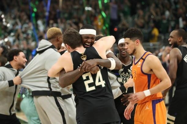 Bobby Portis of the Milwaukee Bucks hugs Pat Connaughton of the Milwaukee Bucks after winning the 2021 NBA Finals on July 20, 2021 at Fiserv Forum in...