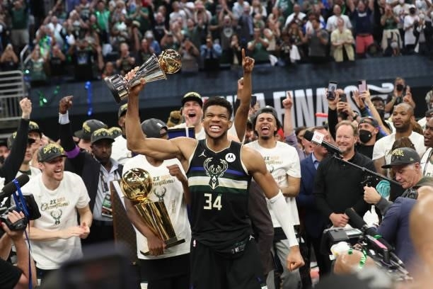 Giannis Antetokounmpo of the Milwaukee Bucks celebrates winning the Bill Russell NBA Finals MVP Award after defeating the Phoenix Suns in Game Six to...