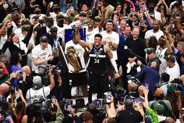 Giannis Antetokounmpo of the Milwaukee Bucks holds up the Bill Russell NBA Finals Most Valuable Player Award after the game against the Phoenix Suns...