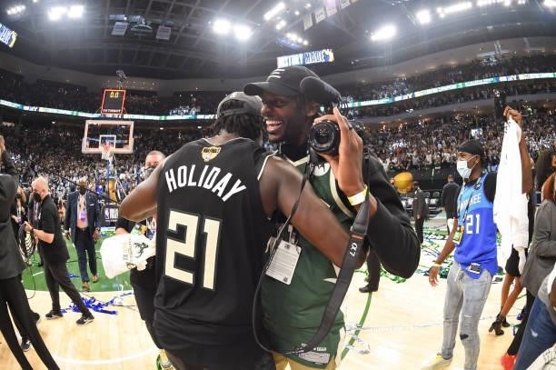 Jrue Holiday of the Milwaukee Bucks hugs Justin Holiday of the Indiana Pacers after defeating the Phoenix Suns in Game Six to win the 2021 NBA Finals...