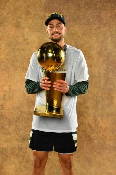 Bryn Forbes of the Milwaukee Bucks poses for a portrait with the Larry O'Brien Trophy after winning Game Six of the 2021 NBA Finals against the...