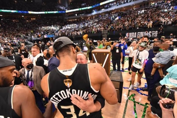 Giannis Antetokounmpo of the Milwaukee Bucks and Head Coach Mike Budenholzer hug after winning Game Six of the 2021 NBA Finals against the Phoenix...