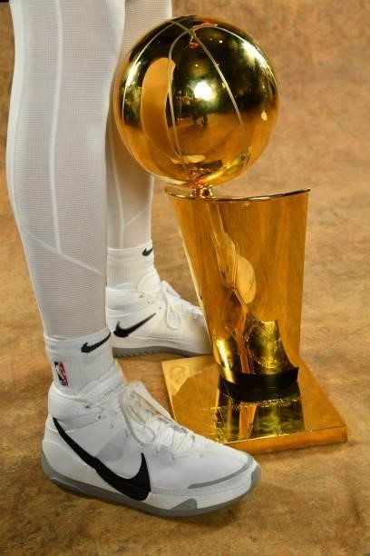 The sneakers of Pat Connaughton of the Milwaukee Bucks are seen with the Larry O'Brien Trophy after winning Game Six of the 2021 NBA Finals against...