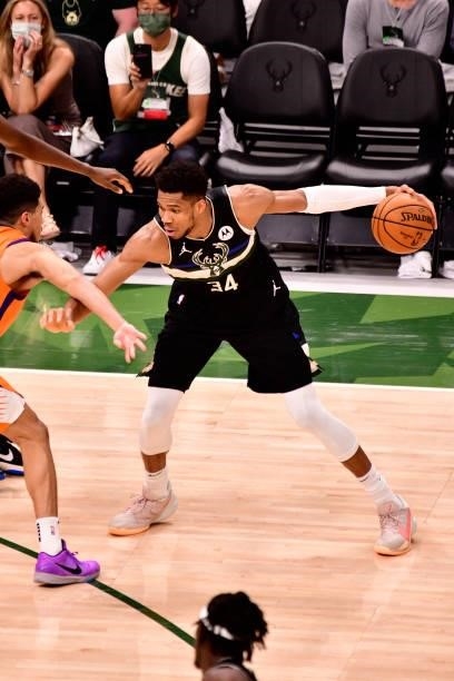Giannis Antetokounmpo of the Milwaukee Bucks handles the ball against the Phoenix Suns during Game Six of the 2021 NBA Finals on July 20, 2021 at the...