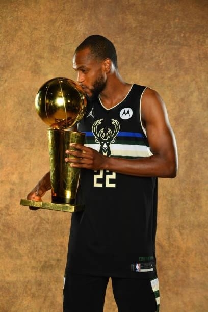 Khris Middleton of the Milwaukee Bucks poses for a portrait with the Larry O'Brien Trophy after winning Game Six of the 2021 NBA Finals against the...