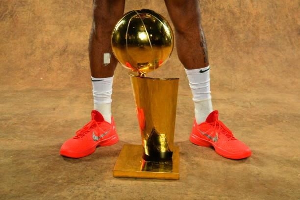 The sneakers of P.J. Tucker of the Milwaukee Bucks are seen with the Larry O'Brien Trophy after winning Game Six of the 2021 NBA Finals against the...