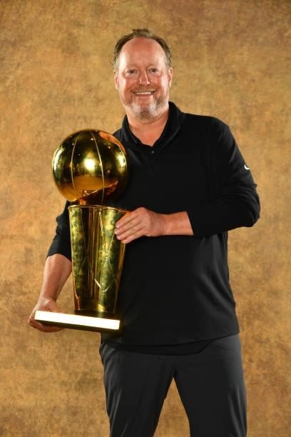 Head Coach Mike Budenholzer of the Milwaukee Bucks poses for a portrait with the Larry O'Brien Trophy after winning Game Six of the 2021 NBA Finals...