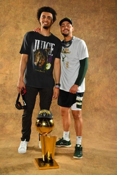 Jordan Nwora of the Milwaukee Bucks and Bryn Forbes of the Milwaukee Bucks pose for a portrait with the Larry O'Brien Trophy after winning Game Six...