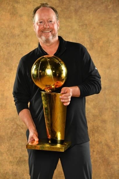 Head Coach Mike Budenholzer of the Milwaukee Bucks poses for a portrait with the Larry O'Brien Trophy after winning Game Six of the 2021 NBA Finals...