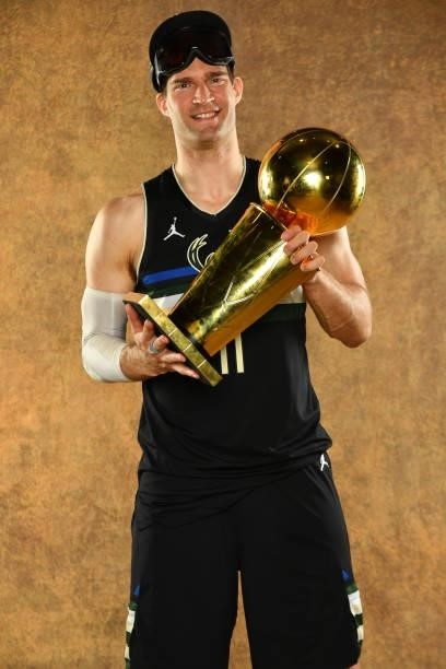 Brook Lopez of the Milwaukee Bucks poses for a portrait with the Larry O'Brien Trophy after winning Game Six of the 2021 NBA Finals against the...