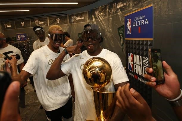 Jrue Holiday of the Milwaukee Bucks celebrates with the Larry O'Brien Trophy after winning Game Six of the 2021 NBA Finals on July 20, 2021 at the...