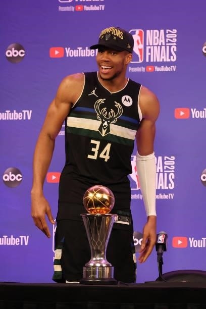 Giannis Antetokounmpo of the Milwaukee Bucks talks to the media with the Bill Russell Finals MVP Award after winning the 2021 NBA Finals on July 20,...