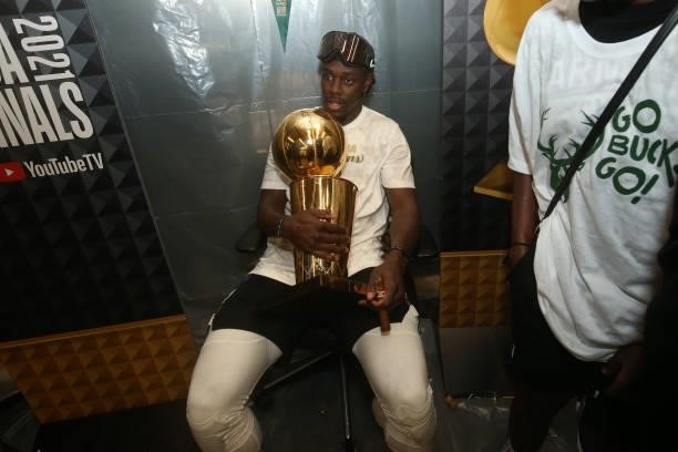 Jrue Holiday of the Milwaukee Bucks celebrates with the with the Larry O'Brien Trophy after winning Game Six of the 2021 NBA Finals on July 20, 2021...
