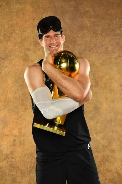 Brook Lopez of the Milwaukee Bucks poses for a portrait with the Larry O'Brien Trophy after winning Game Six of the 2021 NBA Finals against the...