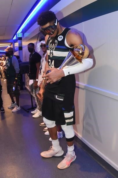 Giannis Antetokounmpo of the Milwaukee Bucks holds the Bill Russell NBA Finals MVP Award after defeating the Phoenix Suns in Game Six to win the 2021...