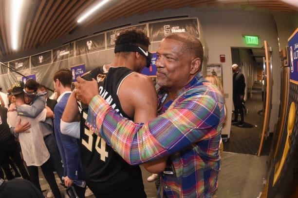 Milwaukee Bucks Analyst Marques Johnson hugs Giannis Antetokounmpo of the Milwaukee Bucks after Game Six to win the 2021 NBA Finals on July 20, 2021...