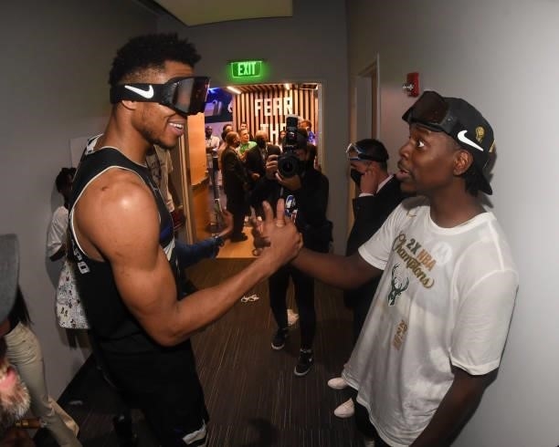 Giannis Antetokounmpo of the Milwaukee Bucks talks to Jrue Holiday of the Milwaukee Bucks after defeating the Phoenix Suns in Game Six to win the...