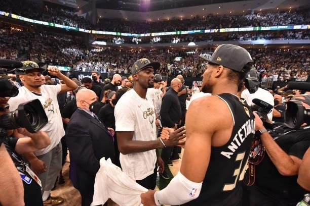 Giannis Antetokounmpo of the Milwaukee Bucks and Bobby Portis of the Milwaukee Bucks high-five after winning Game Six of the 2021 NBA Finals against...