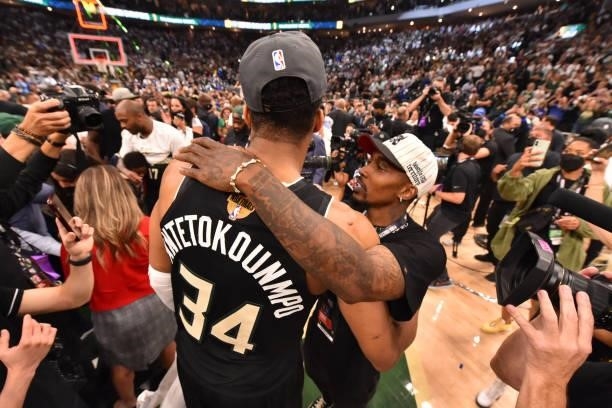 Giannis Antetokounmpo of the Milwaukee Bucks hugs Former NBA Player, Brandon Jennings after winning Game Six of the 2021 NBA Finals against the...