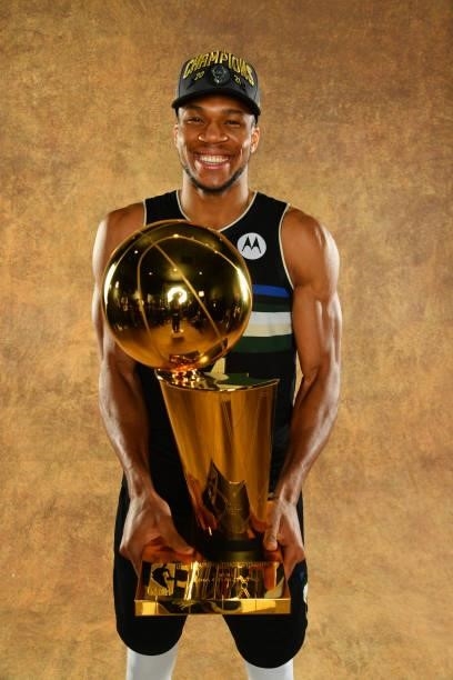 Giannis Antetokounmpo of the Milwaukee Bucks poses for a portrait with the Larry O'Brien Trophy after winning Game Six of the 2021 NBA Finals against...