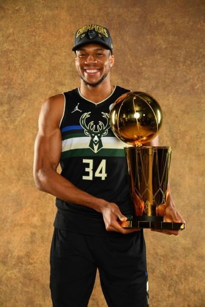 Giannis Antetokounmpo of the Milwaukee Bucks poses for a portrait with the Larry O'Brien Trophy after winning Game Six of the 2021 NBA Finals against...