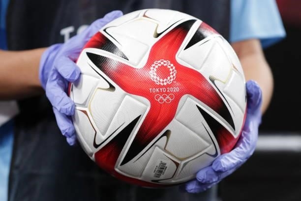 Person holds the official football before the Tokyo 2020 Olympic Games women's group E first round football match between Great Britain and Chile at...