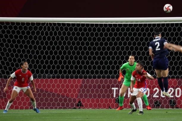 Chile's midfielder Nayadet Lopez looks at Britain's defender Lucy Bronze heading the ball in front of Chile's goalkeeper Christiane Endler and...