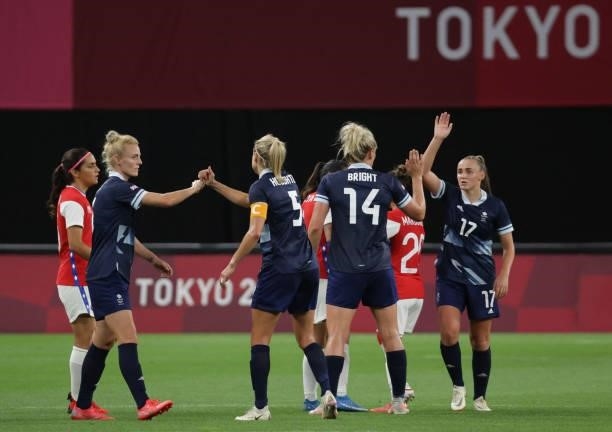 Britain's players celebrate their victory at the end of the Tokyo 2020 Olympic Games women's group E first round football match between Great Britain...