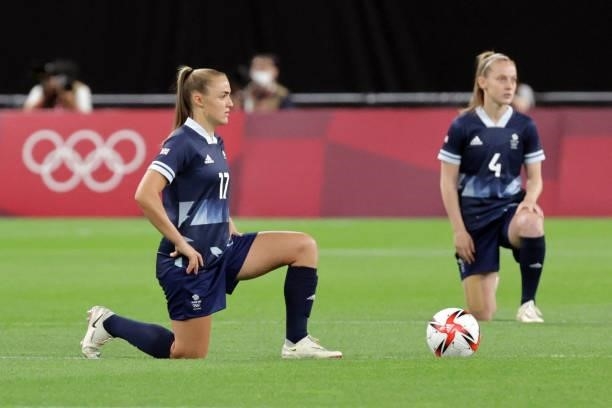 Britain's forward Georgia Stanway and Britain's midfielder Keira Walsh take a knee before the Tokyo 2020 Olympic Games women's group E first round...