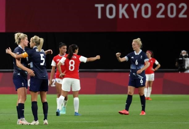 Britain's players celebrate their victory at the end of the Tokyo 2020 Olympic Games women's group E first round football match between Great Britain...