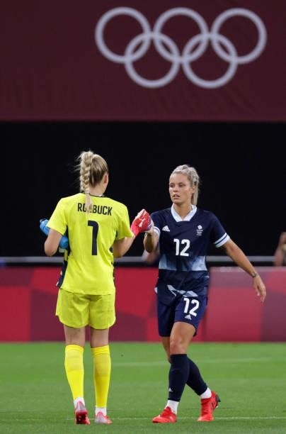 Britain's goalkeeper Ellie Roebuck and Britain's defender Rachel Daly celebrate their victory at the end of the Tokyo 2020 Olympic Games women's...