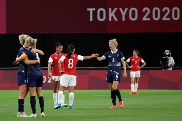 Chile's midfielder Karen Araya congratulates Britain's midfielder Sophie Ingle at the end of the Tokyo 2020 Olympic Games women's group E first round...