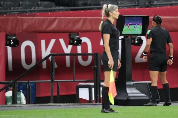 Brazilian referee Edina Alves checks the VAR during the Tokyo 2020 Olympic Games women's group E first round football match between Japan and Canada...