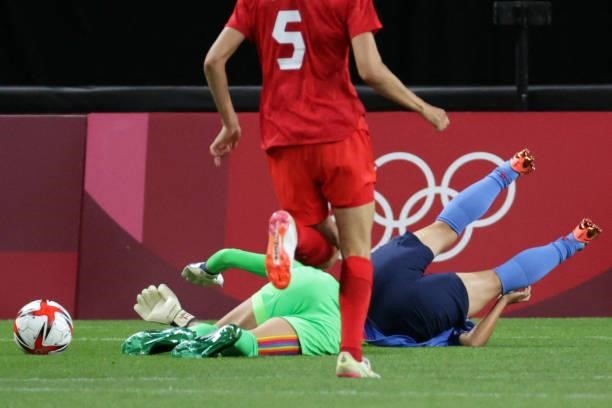 Canada's goalkeeper Stephanie Labbe is fouled by Japan's forward Mina Tanaka during the Tokyo 2020 Olympic Games women's group E first round football...