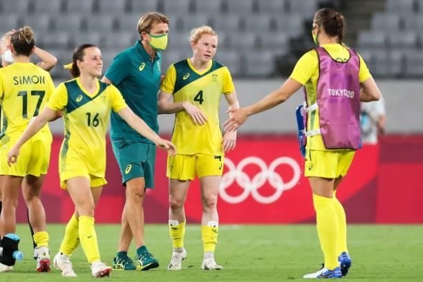 Australia's coach Tony Gustafsson congratulates Australia's defender Clare Polkinghorne at the end of the Tokyo 2020 Olympic Games women's group G...