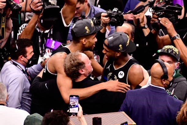 Giannis Antetokounmpo Khris Middleton and Head Coach, Mike Budenholzer of the Milwaukee Bucks hug after winning Game Six of the 2021 NBA Finals...