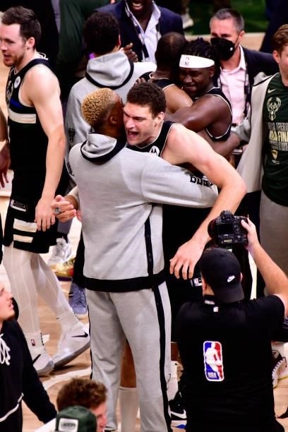 Brook Lopez hugs Mamadi Diakite of the Milwaukee Bucks after winning Game Six of the 2021 NBA Finals against the Phoenix Suns on July 20, 2021 at the...
