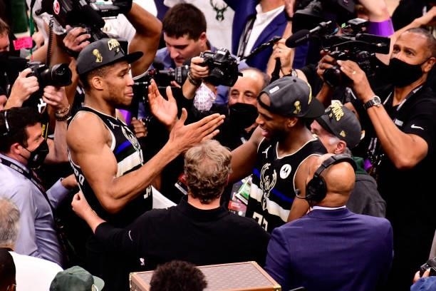Giannis Antetokounmpo and Khris Middleton of the Milwaukee Bucks high five after winning Game Six of the 2021 NBA Finals against the Phoenix Suns on...