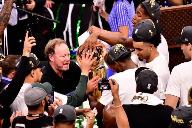 Head Coach, Mike Budenholzer of the Milwaukee Bucks holds the Larry O'Brien Trophy after winning Game Six of the 2021 NBA Finals against the Phoenix...