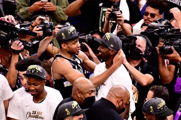 Giannis Antetokounmpo and Bobby Portis of the Milwaukee Bucks share a conversation after winning Game Six of the 2021 NBA Finals against the Phoenix...
