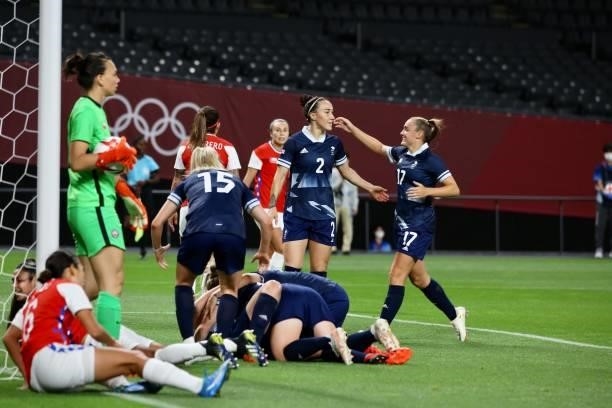 Ellen of Team Great Britain celebrates with teammates after scoring their first goal during the Women's First Round Group E match between Great...