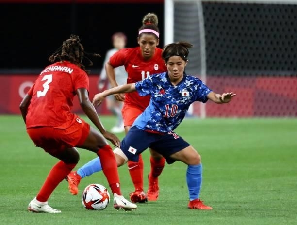 Mana of Team Japan battles for possession with BUCHANAN Kadeisha of Team Canada during the Women's First Round Group E match between Japan and Canada...