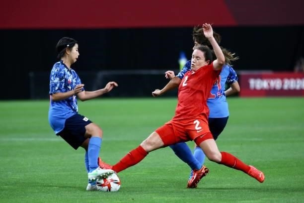 Allysha of Team Canada battles for possession with 2 of Japan players during the Women's First Round Group E match between Japan and Canada during...